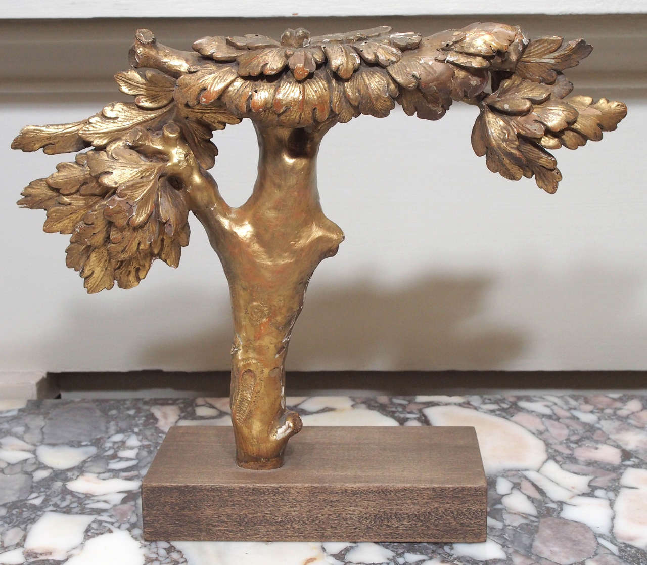 An 18c. finely carved and gilded tree, mounted on a contemporary base.