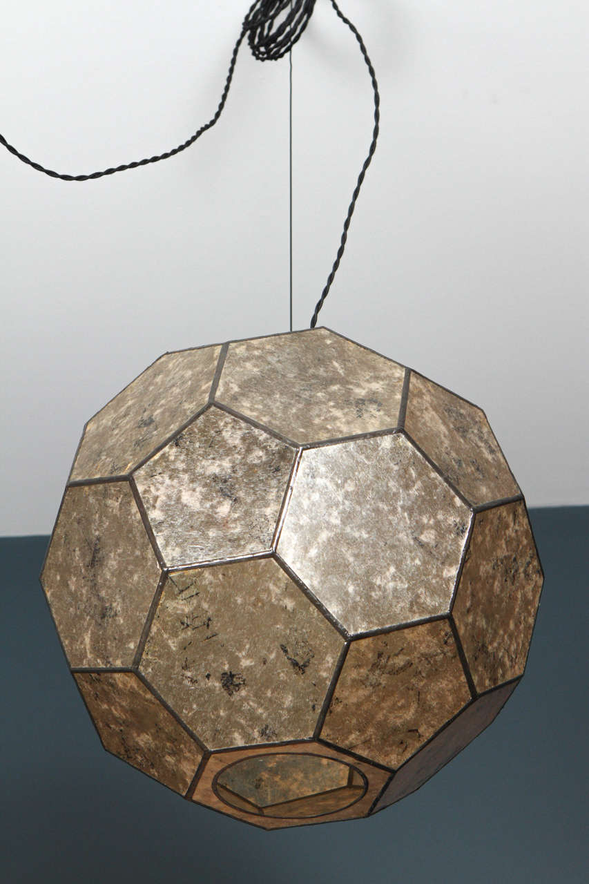 Leaded Mica globe pendant constructed from translucent sheets of Mica to create a warm diffused light suitable for all settings where natural, ambient lighting is needed.