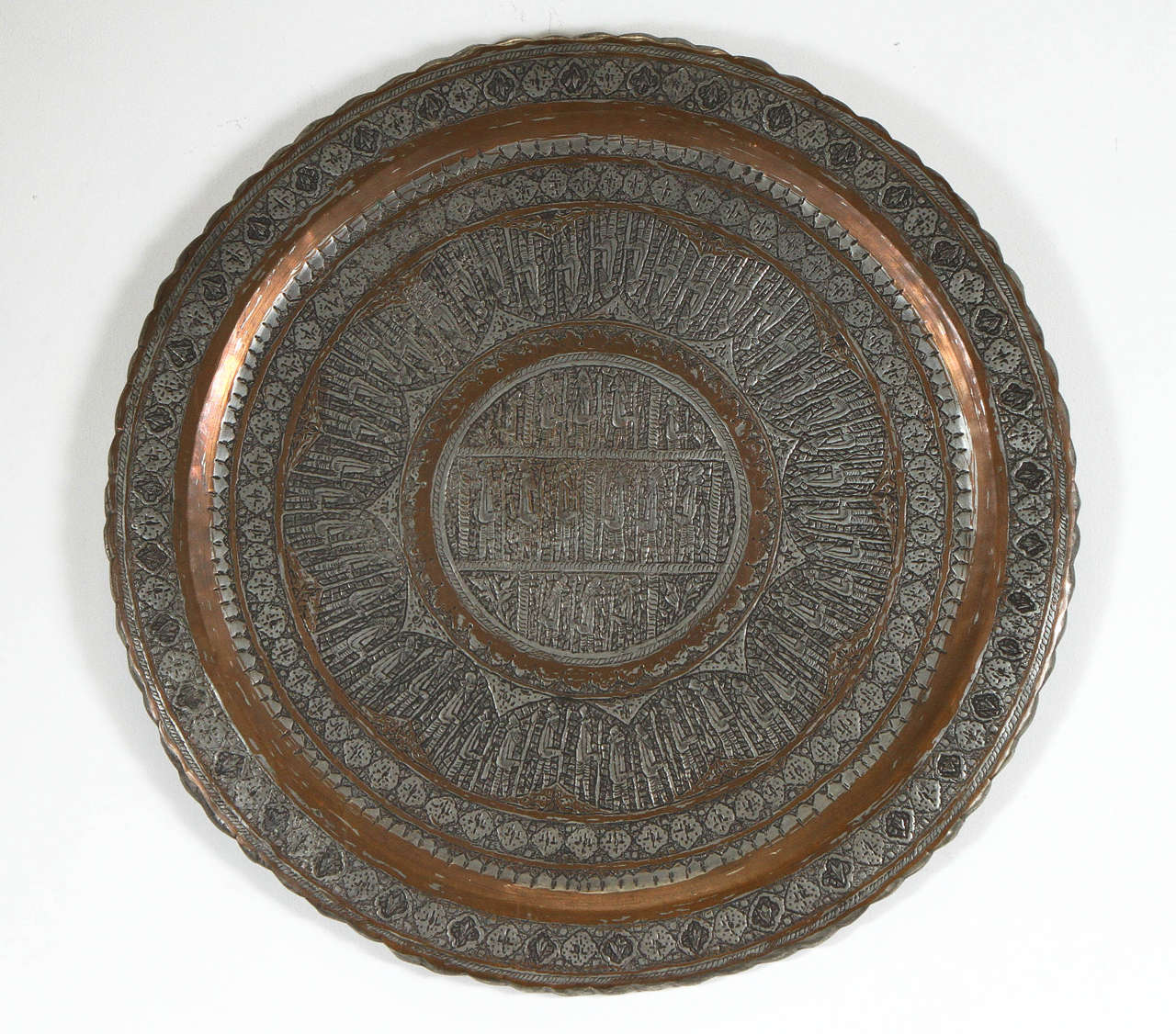 Silver and copper inlaid antique Persian wall hanging charger.
Nicely hand hammered with floral details and figural scenes.
Copper and silver color metal. Museum quality piece.
Has a hook in the back for hanging.