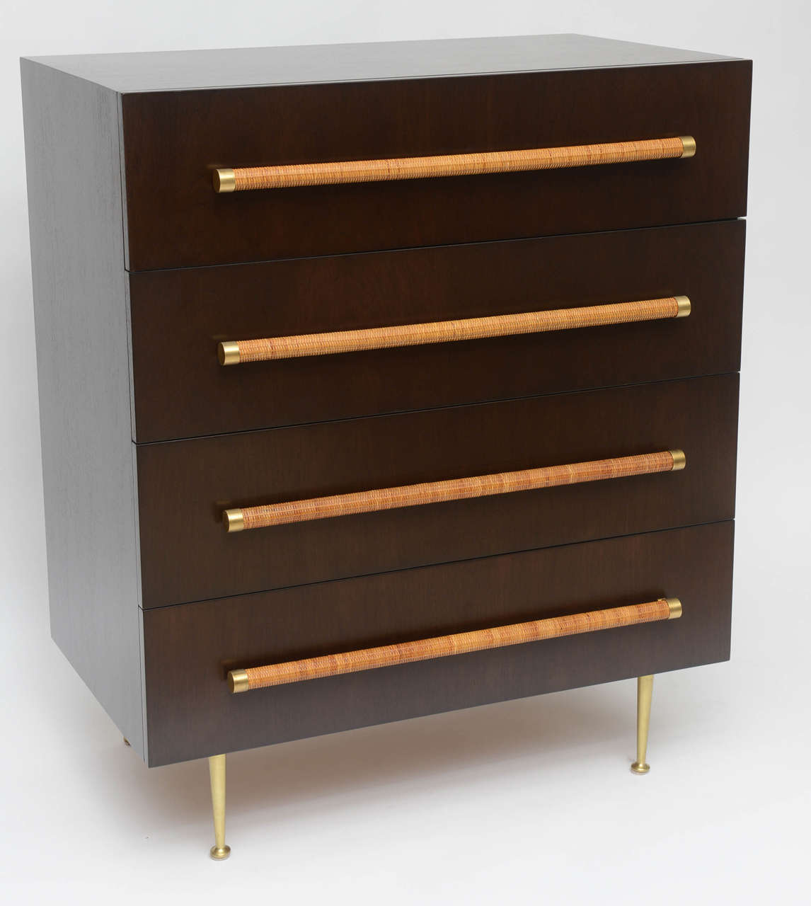 Beautifully restored four-drawer dresser by T. H. Robsjohn-Gibbings in dark, espresso-stained walnut. Brushed brass legs and end caps on rattan-wrapped drawer pulls. Remains of Widdicomb label inside top drawer. A handsome Classic piece with a