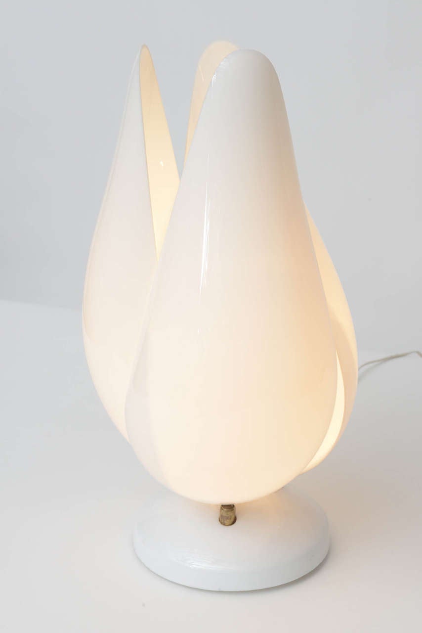 Delightful tulip lamps in the manner of Roger Rougier. Pivoting opaque white acrylic petals can be adjusted open or closed. White enameled metal bases.