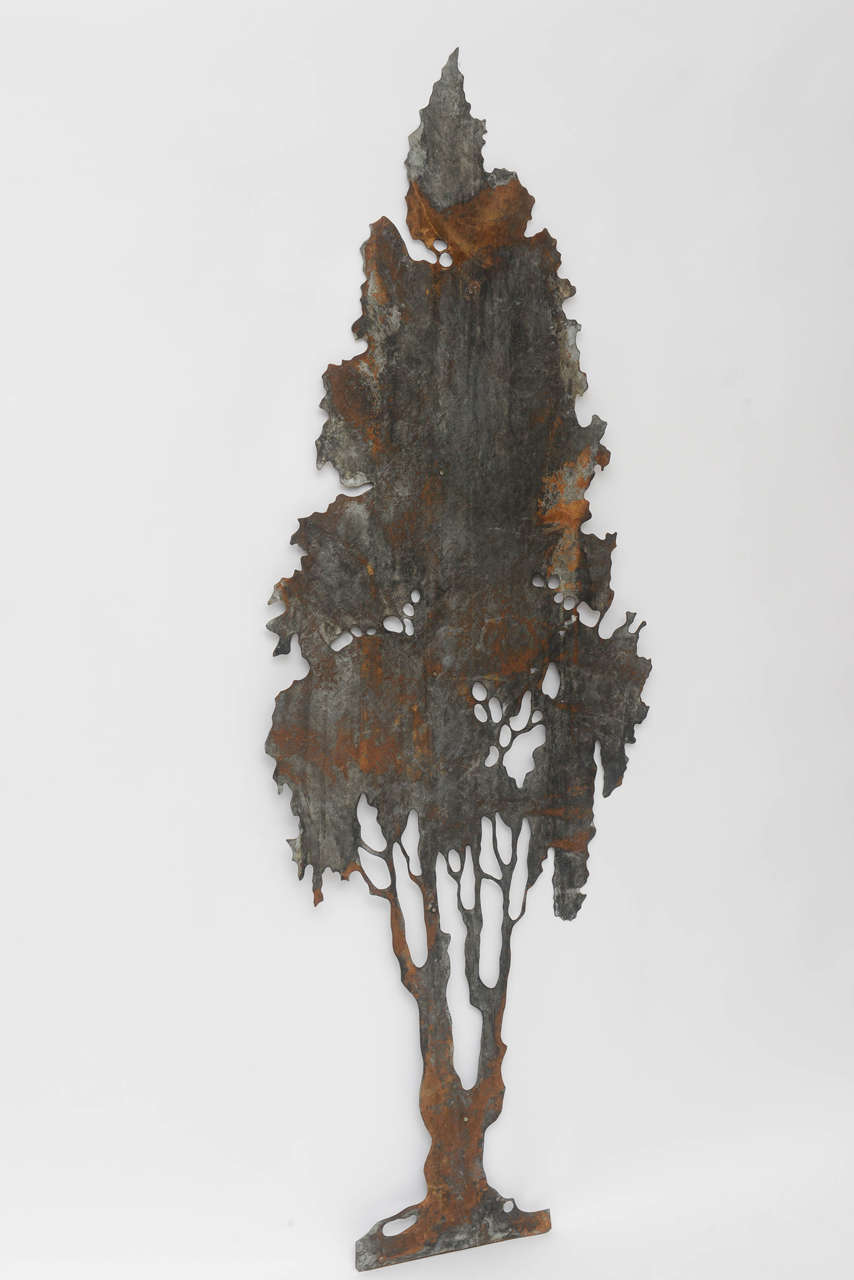 An impressive piece of Folk Art, this hand-cut sheet metal tree is looped on back to hang as a wall sculpture. Original rust and patina. See photos for two other trees in the original group of three. Priced individually. Artist unknown.