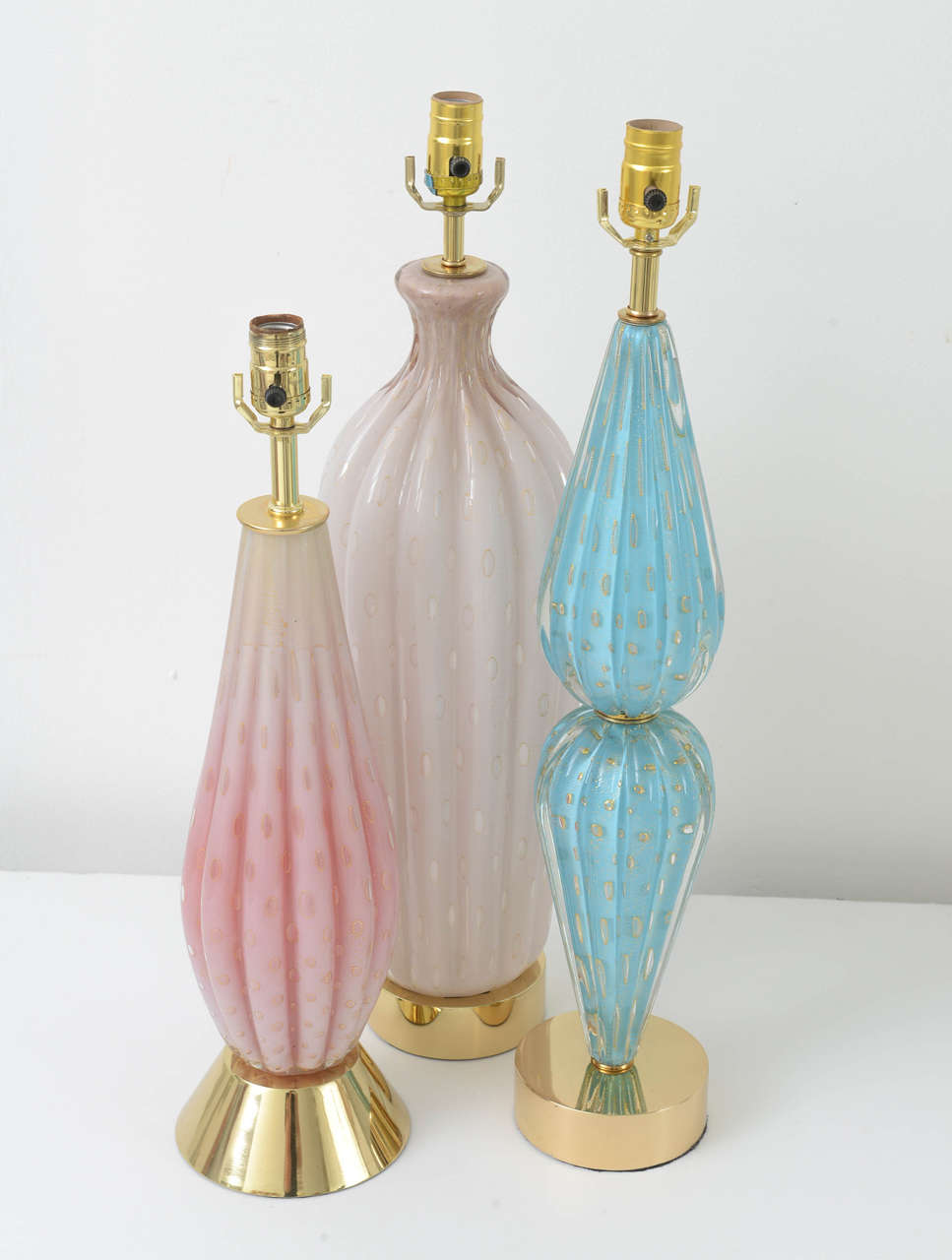 A selection of single Barbini lamps. All are ribbed Murano glass, with controlled bubbles, gold leaf inclusions, and solid brass hardware, professionally polished. Colors are pink, robin's egg blue, and softest mauve. Measurement below is for mauve