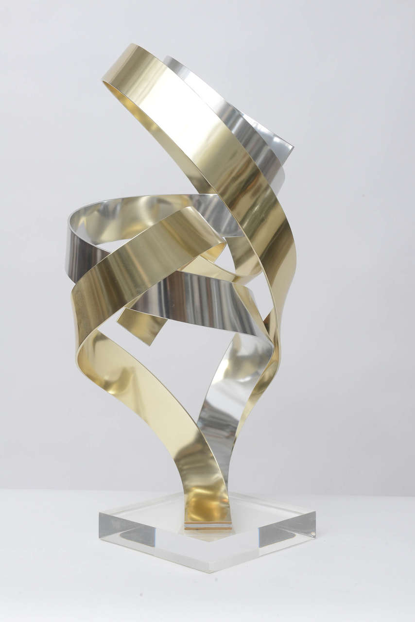 Large limited edition ribbon sculpture in gold and silver anodized aluminum by Dan Murphy. Signed, 11/80, 1996.