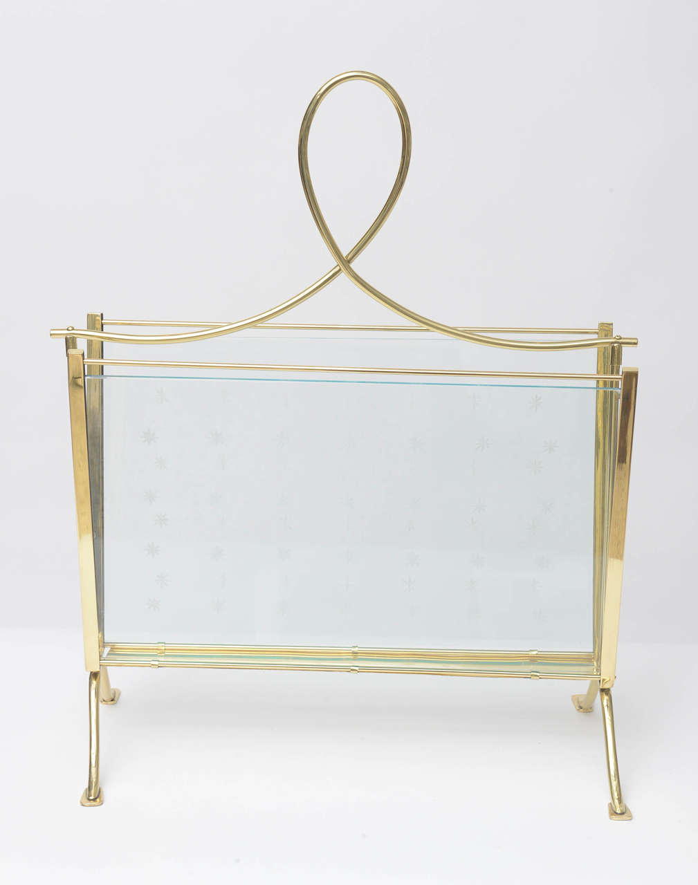 A glamorous, 1940s Italian magazine rack with polished brass frame and cut-glass side panels, etched with a delicate star pattern. Professionally polished.