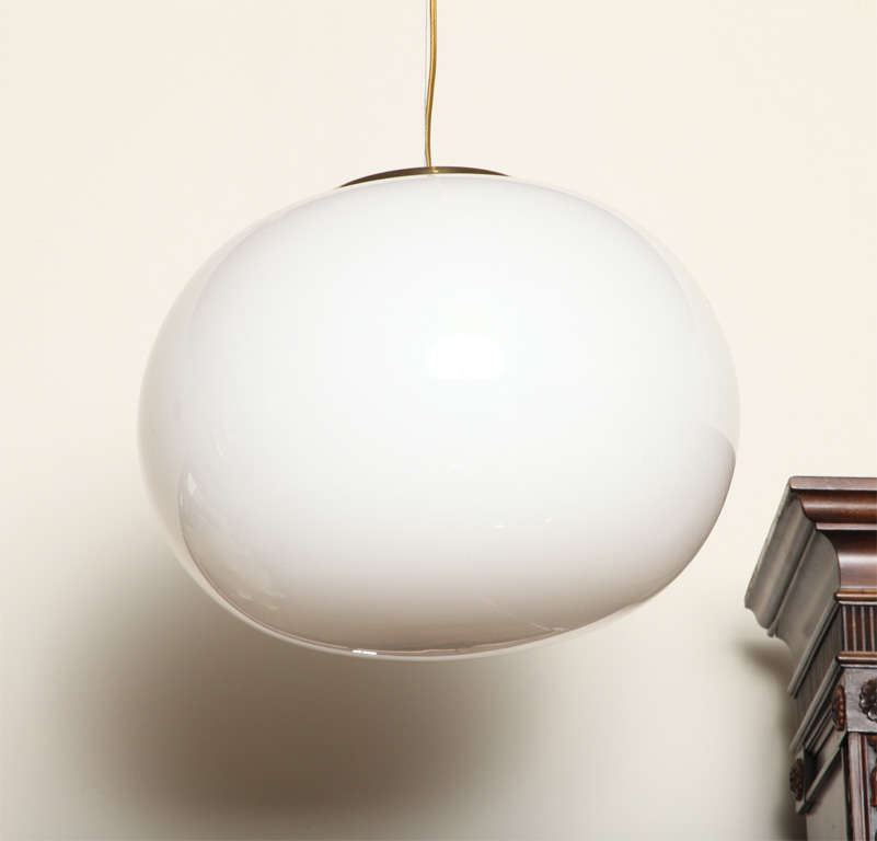 Re-wired for US standards, this stunning irregular sphere in white Murano glass hangs from a steel cable and has original brass canopy. Triangular faded label is attached to bottom of glass. Can accommodate up to 100w.

 