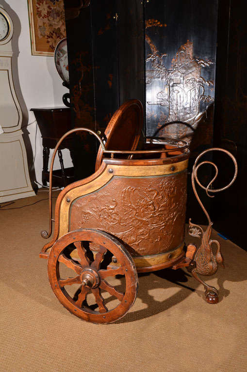 a oak wine chariot clad in copper repousse' with swan stand,
shield decorated with repousse' Medussa's head flips to become a sturdy serving table 

purportedly from the estate of American Broadway impresario Flo Ziegfeld and his wife, actress