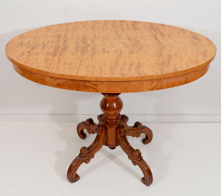 A higher table to be used for enjoying coffee or sherry and for displaying collectables. A beautiful veneered surface sits atop a turned base and carved legs that are solid birchwood. A beautiful French polish makes the table glisten and gleam.