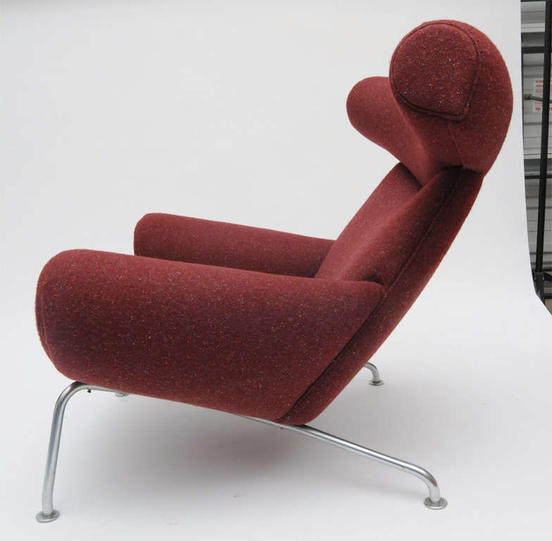 Hans Wegner Ox Chair and ottoman,model #'s 46 and 49.
Early production upholstered in cranberry wool.
A  large and comfortable set.