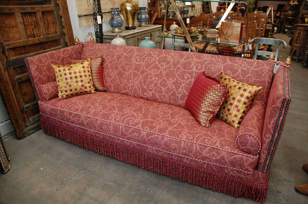 A new custom knole sofa with old Italian finials and a 
stunning new upholstery and extravagant tasseled ties.
The name Knole comes from Knole house in Kent where what is believed to be the early 17th.c prototype resides.
The high sides were ideal