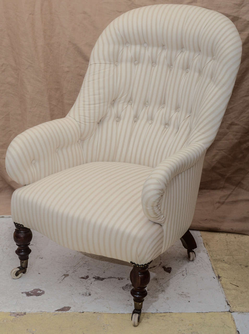 BEAUTIFULLY SCALED TURKISH FRAME TUFTED ARM & BACH UPHOLSTERED CHAIR WITH ROSEWOOD LEGS ON CASTORS-- COVERED IN IAN MAKIN TICKING #2 (CREAM) VERY COMFORTABLE