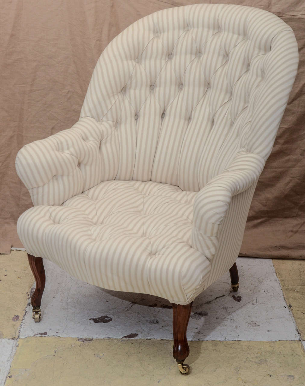 LARGE SCALE NAPOLEON 111  TUFTED SEAT & BACK ARMCHAIR WITH MAHOGANY CABRIOLE LEGS ON CASTORS. VERY COMFORTABLE --COVERED IN IAN MAKIN TICKING #2 ( CREAM )