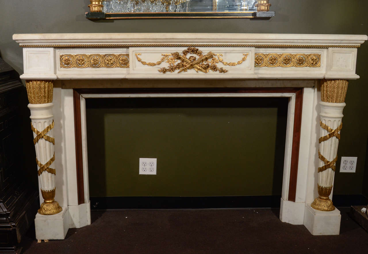 A palatial and magnificent large antique French Louis XVI style gilt bronze mounted carved white marble fireplace of exceptional workmanship embellished with superb gilt bronze mounts.