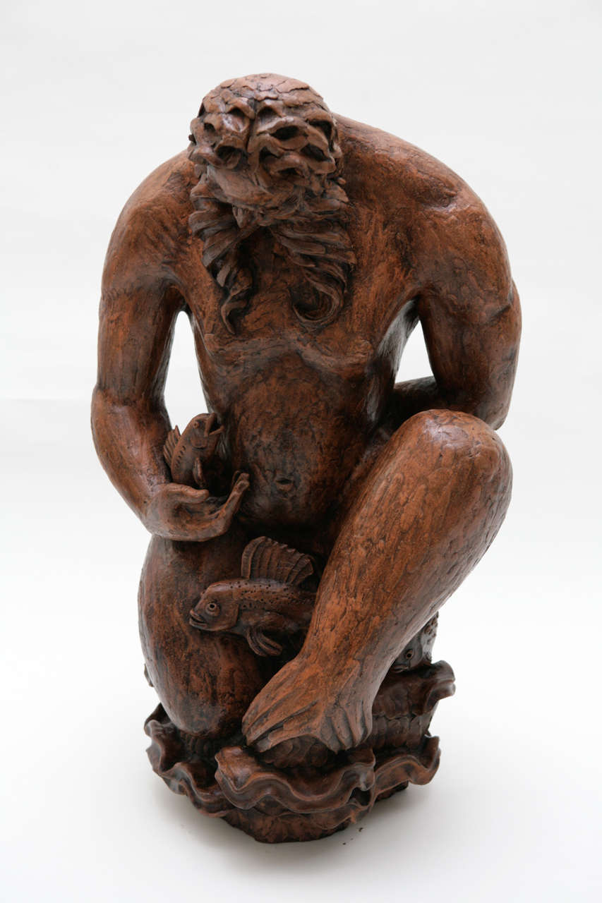 A majestic terra cotta sculpture of Poseidon by California sculptor John Edward Svenson. This large scale sculpture features Poseidon with fishes and waves. Signed by the artist on the side of the sculpture (see Image 7). This sculpture has been