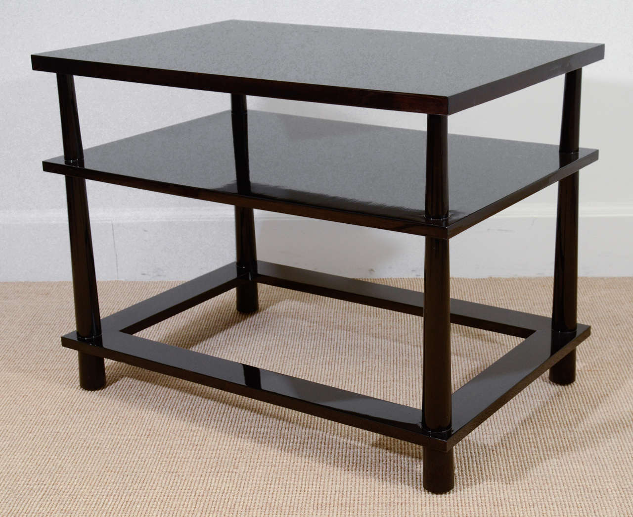 Each with a high middle shelf and a lower open shelf, all supported by inverted tapering cylindrical legs.
