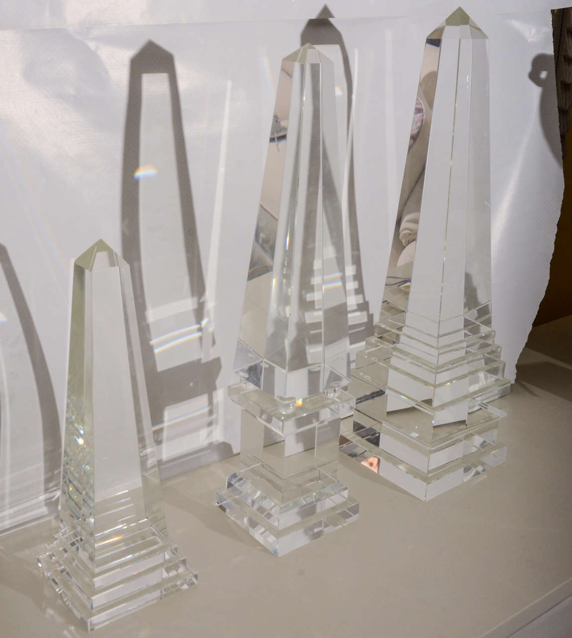 Set of three crystal obelisks, beautiful on a console or coffee table. So Clean and Beautiful looking.

One has a minor chip on base, regular price 2375.00 on sale for 1275.00.