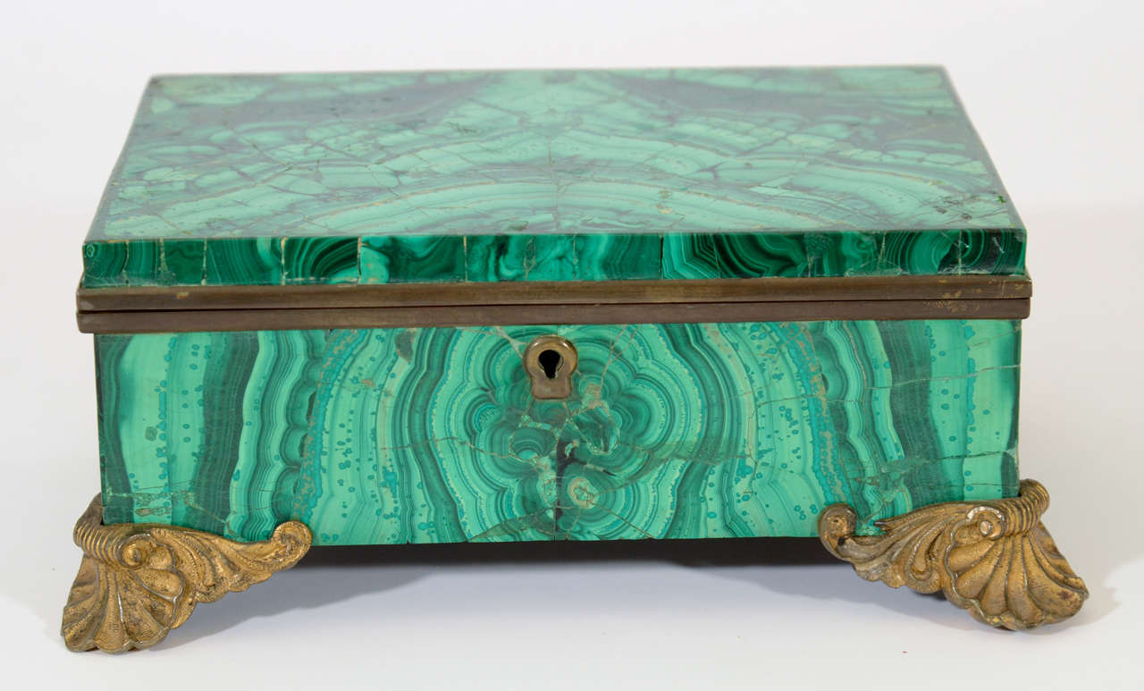 Impressive Russian Gilt Bronze and Malachite Jewelry Box on Gilt Bronze Feet.  Interior Features a Mirror and Aubergine Velvet Lining.  Russia, 19th Century

8 inches wide x 5.75 inches deep x 3.25 inches high