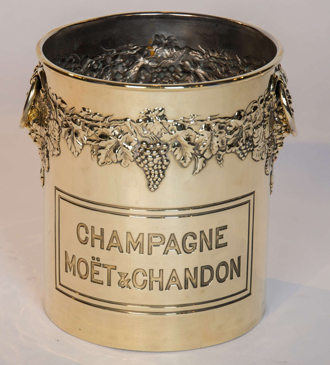 A Mid 20th century brass champagne bucket, the repousse decoration of vines all round with two rig handles.