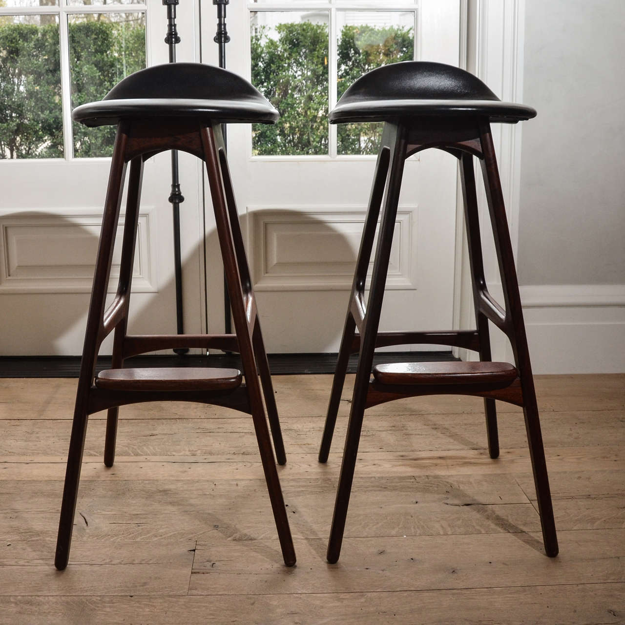 Stunning Set of Six 1960's Eric Buch Barstools in Rosewood and newly upholstered in black leather. The legs are elegant yet solid crafted in beautiful rosewood.