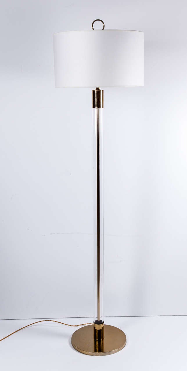 Pair of elegant floor lamp with glass stem and brass elements by Laurel. USA, circa 1960.  Newly rewired; each lamp takes a standard U.S. bulb, 75 watts max.

Dimensions:
61.5 inch overall height to finial
49.5 inch height to socket base
11