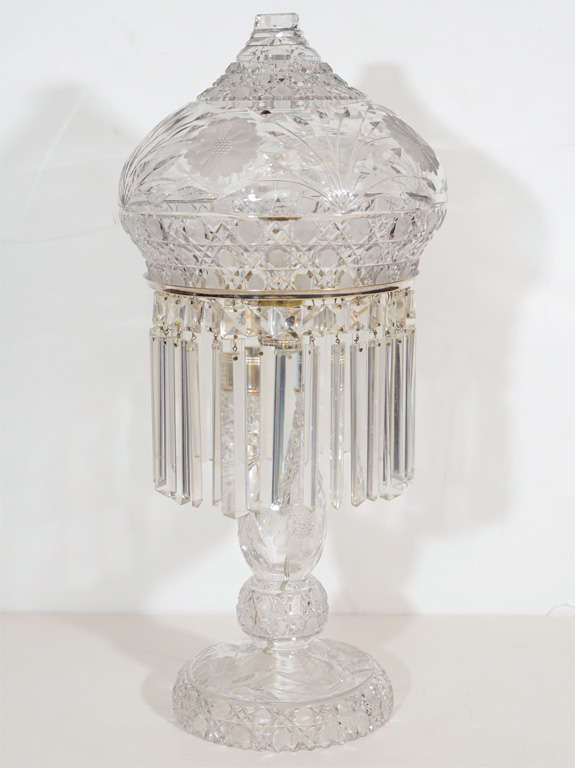 This lavish lamp features fine hand cut crystal detailing and etching with a stylized geometric design and botanical details. It also has silvered fittings and has been completely rewired as well.