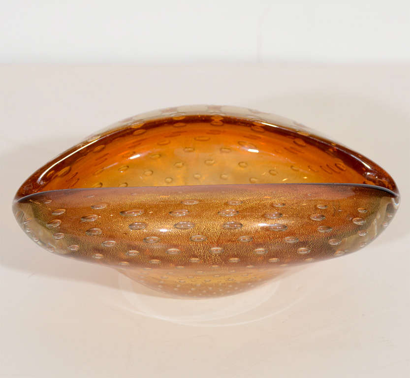 Modernist hand blown Murano glass bowl with 
free form design.  Bowl has amber and copper 
hues with bubble design as well as gold flecks
details.  Makes an excellent ashtray as well as
a decorative object or bowl.