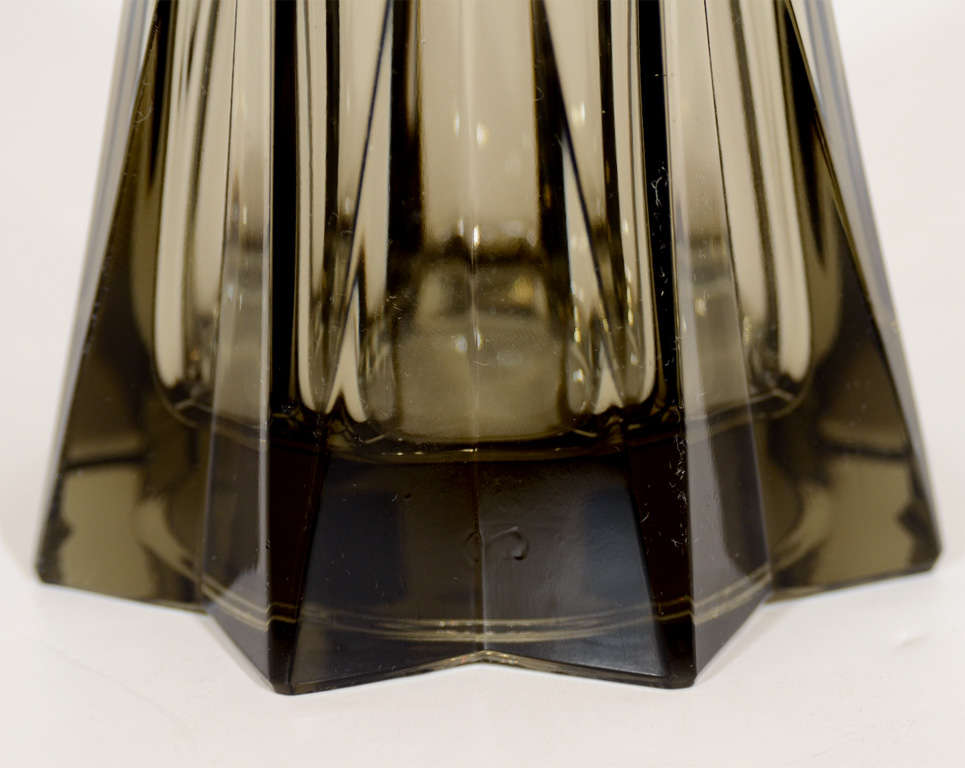 This stylized Cubist Art Deco decanter features an octagon shaped top resting in a stylized diamond cut crystal holder.