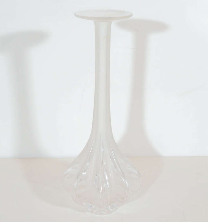 This stunning vase was blown by hand by Marie Claude Lalique, arguably France's most esteemed producer of glass ware. This opalescent glass vase features an elongated and slender neck with a flaired opening at its apex. The base has eight peaked
