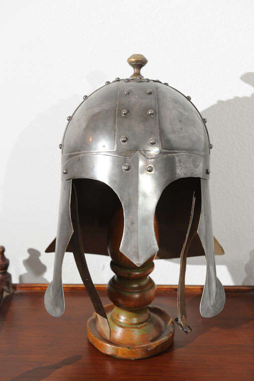 A polished iron Scottish Burgonet helmet on wooden stand