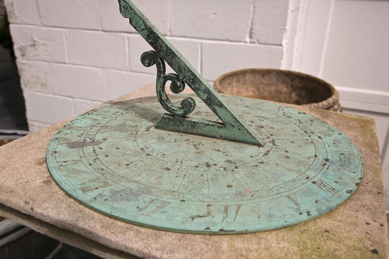 Barker & Sons London, bronze and limestone sundial having an unusually large dial and gnomon.
