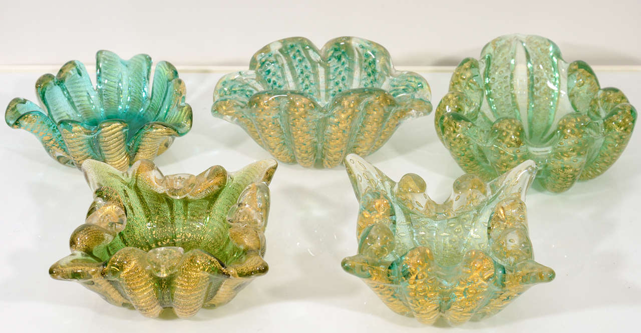 A set of five 1950s Murano glass bowls in various shades of green glass with cordonato d'oro and bullicante ornamentation. By Barovier.
Varying sizes - smallest 6