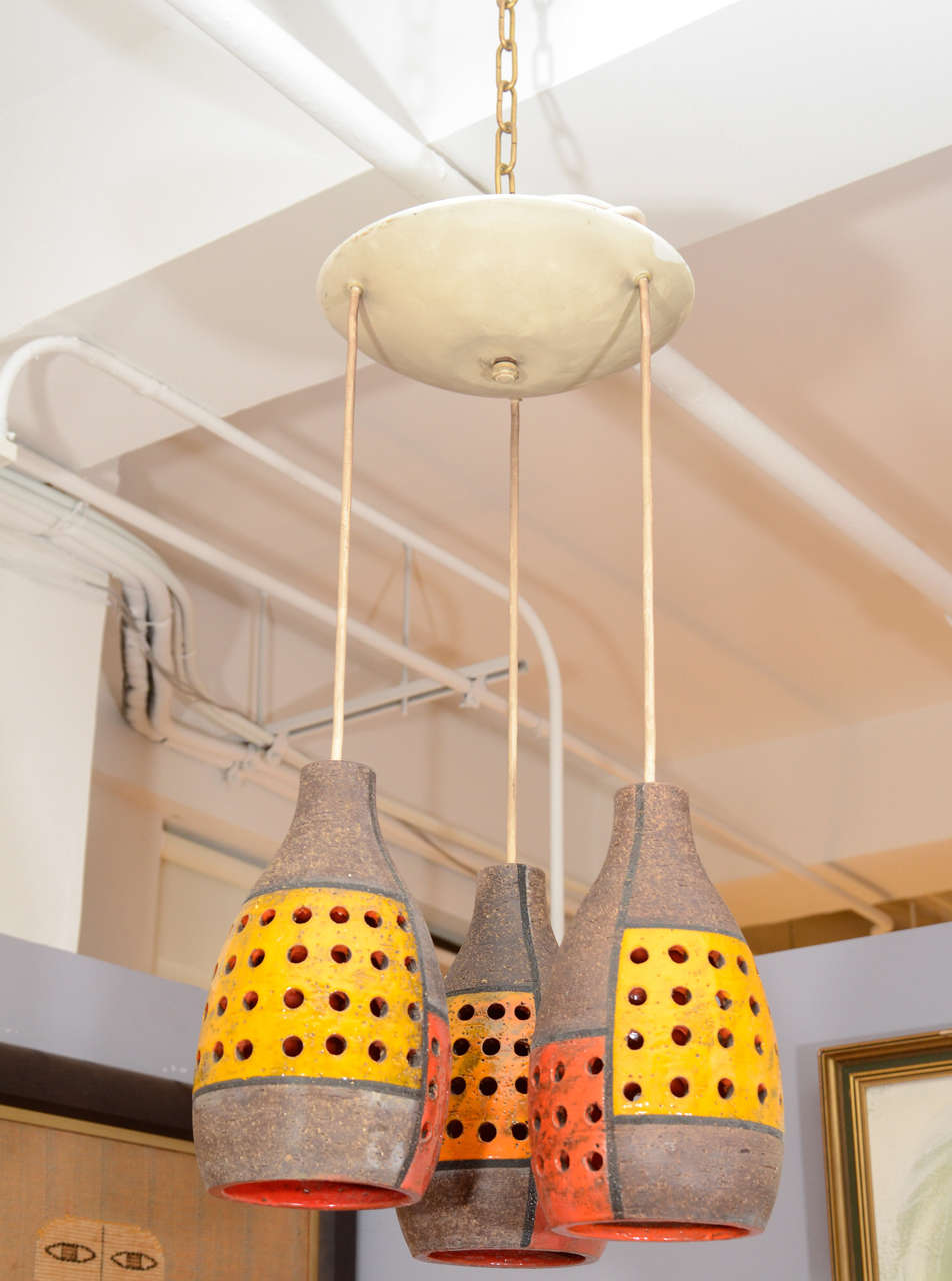 Mid-century Ceramic Pendant Light with 3 perforated ceramic lights 
suspended from a round ceiling mount.
Each 13.5