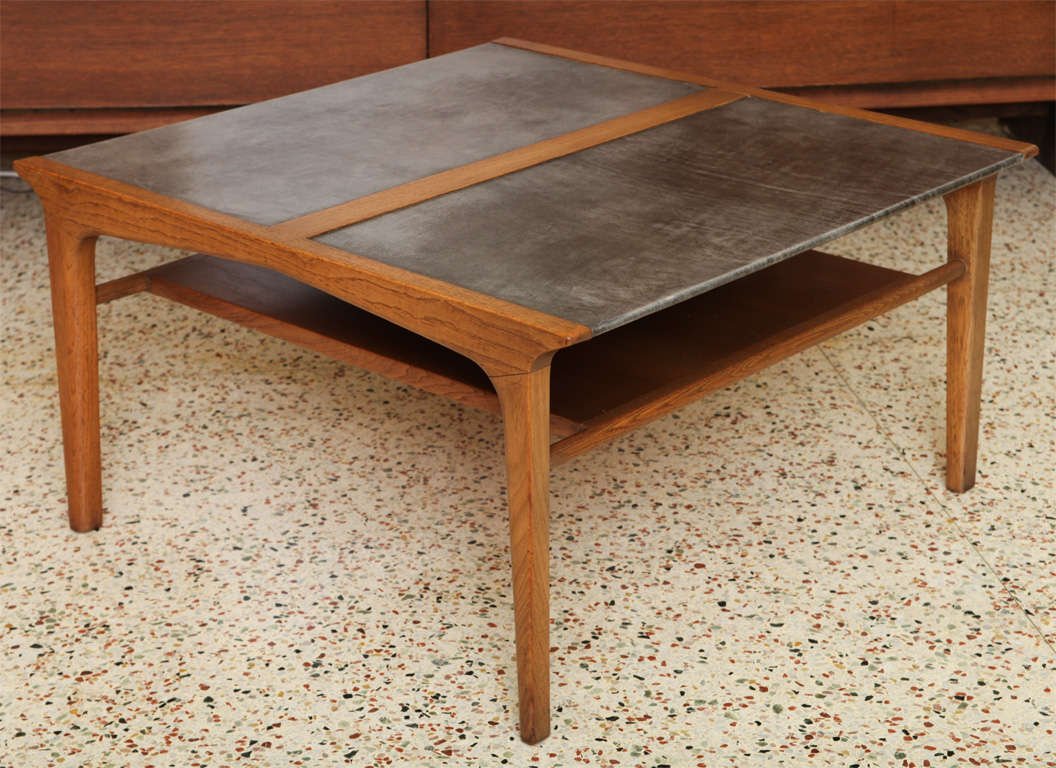 As a cocktail table, front and center or a side table, this leather top table by John Van Koert's Profile Line for Drexel is quite stylish and sophisticated.  The grey leather top is richly beautiful.  In magnificent original condition, it has a