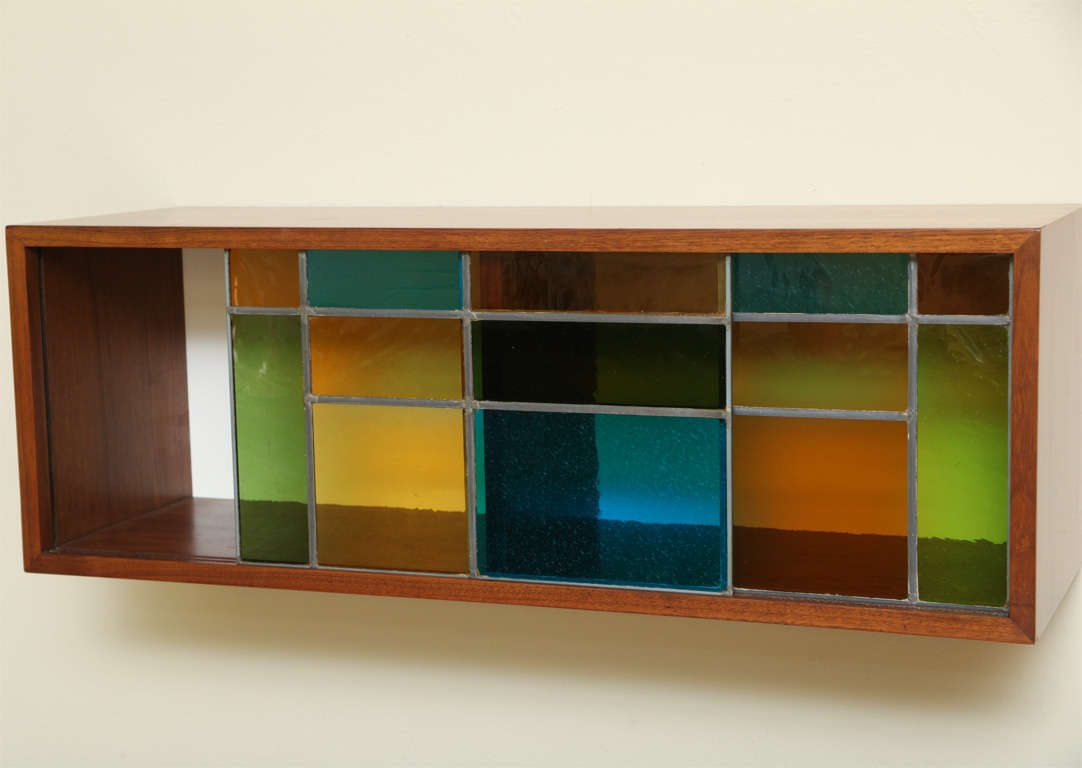 SOLD JUNE 2011 A custom design for a 1958 NYC batchelor's pad, this wall mount cabinet shelf has sliding stained glass doors and a beautifully figured walnut body.  The back inside is white laminate masonite.  With a center divider, the glass doors