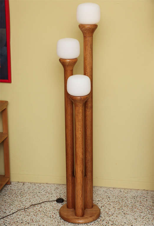 SOLD NOV 2012 The look is clean, natural...70's green with this floor lamp designed and made by Modeline.  Solid oak shaped into three staggered lamp posts with blown white satin globes.  Sculptural California design.  Excellent condition.