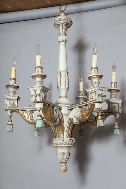 Polychromed and parcel gilt chandelier, having a standard of carved wood, six carved wood candlearms carved with acanthus leaf, scroll, Greek key and rosette designs, each with tassel.  Electrified.

Stock ID: D4540