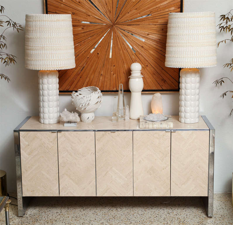 Let me count off some of the (many) reasons we love this Ello buffet... Cold polished steel against warm and sandy, tesseleated travertine... sleek and simple modern design paired with stone tile laid out in a very Old World herringbone pattern. The