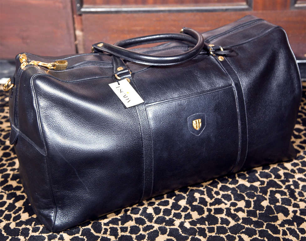 the funkyfinders 'studio' is pleased to share this ultra-rare, unisex, black calf leather weekender/carry-on from the house of escada. this eye-catching, minimalist, made in italy piece debuts with its original boutique tag, lock, key, brass feet,