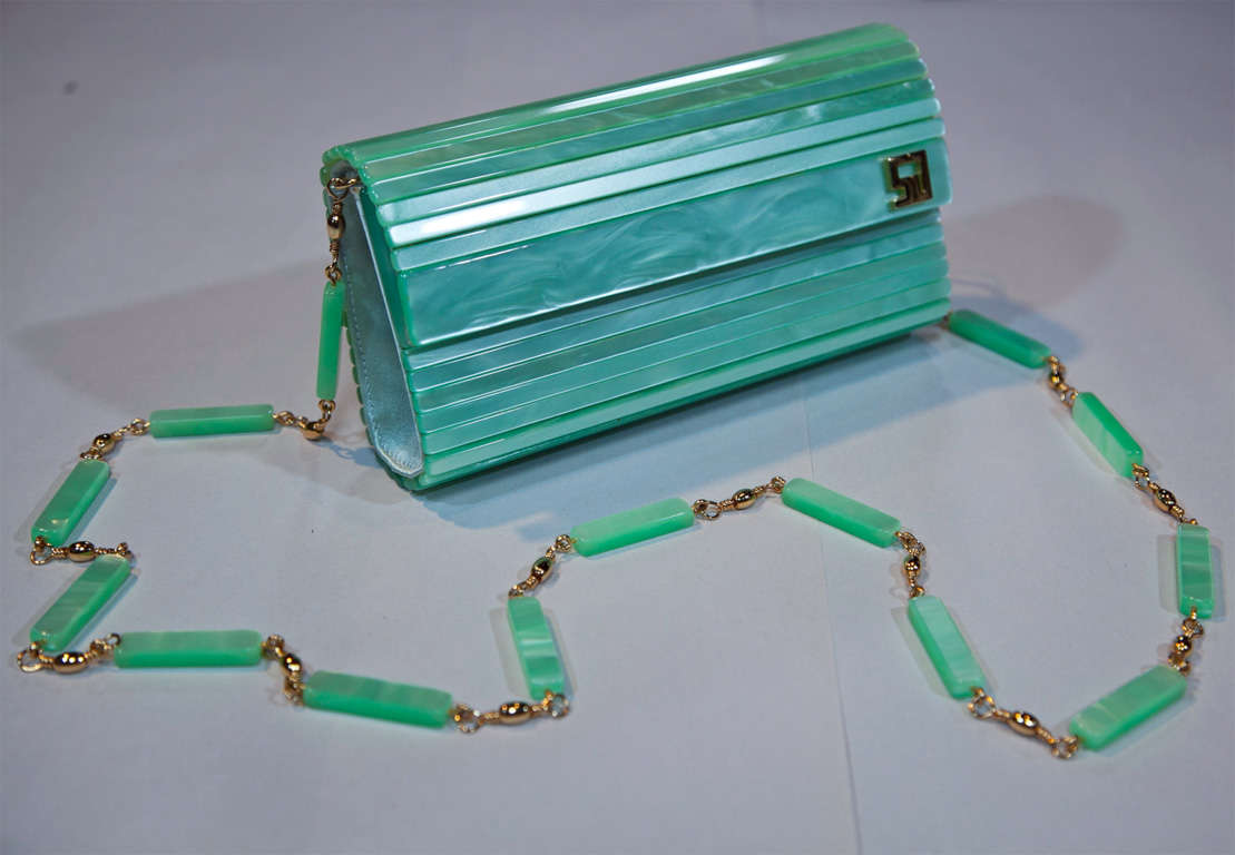 fresh from the funkyfinders 'studio' vintage fashion archive is this conversational lucite purse from the house of st. john. this marvelous accoutrement debuts in 'new with tag' condition: ready for gift-giving for someone special or yourself. the