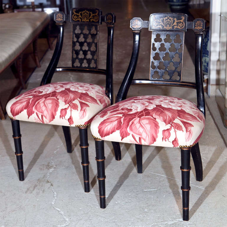 These ebonized black regency chairs have been newly reupholstered in gorgeous Ralph Lauren fabric for a charming upbeat look.