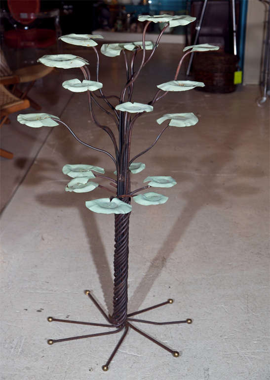This delightful wrought iron garden sculpture is a must-have this lovely summer season!  With it's sweet twisting trunk and multi-layered lily pad motif, this great little piece will add such character and charm to your garden.