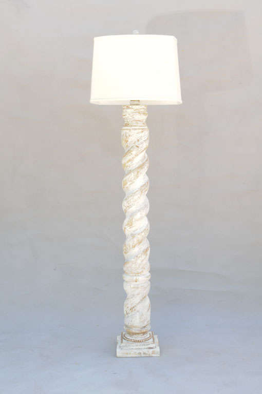 Pair of floor lamps, each a wooden column in barley twist shape, having distressed painted finish, raised on square plinth with beading; shown with linen shades.