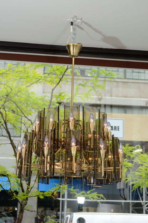 Part of the series with our other sconces, large-scale chandelier with twenty-four lights and amber glass panes.