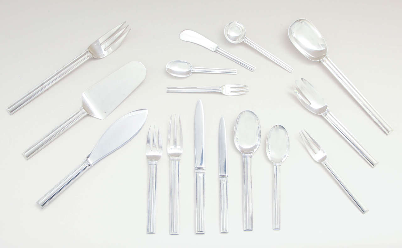 109 Pieces - 161.85 ozs.

A unique cubistic design with cylindrical centre of handle and bands encircling top of handle.

This pattern was selected by Jean Puiforcat for his own personal set of silverware at the time of his marriage to Marta