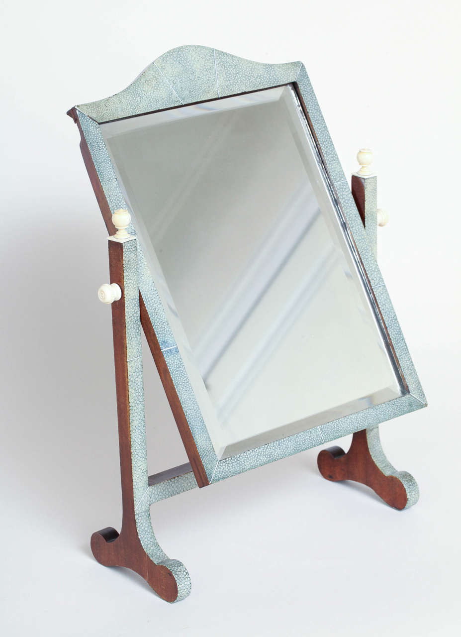 Beveled mirror in shagreen-covered frame tilts on shagreen-covered mahogany stand
and with mahogany back.
Good vintage condition with original mirror.  There is a small piece of mahogany missing from the back, but this is not visible from the