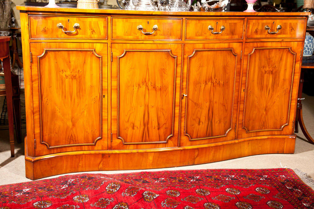 YEW WOOD BUFFET.  FOUR DRAWERS AND FOUR DOORS-  MADE IN ENGLAND. ADJUSTABLE SHELVES BEHIND DOORS,, SELF CROSS BANDED TOP AND DOOR BORDERS. LOCKS ON DOORS AND DRAWERS