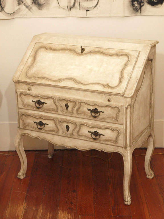 Absolutely breathtaking, this Louis XV drop leaf secretary has gorgeous carvings and original bronze hardware.  Cabriole legs and working original keys.  Painted in a a gorgeous French Canvas color with dark french grey details.  Absolutely a work