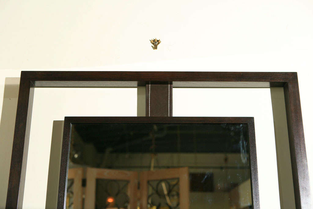 Modern Paul Marra Negative Space Mirror shown in dark walnut outer and inner frames, dark brown top-stitched leather strut.