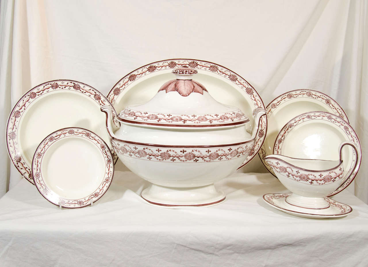 A creamware dinner service decorated on the border with an elegant brown painted necklace design. The finials of the tureen and covered dishes are decorated with brown painted leaves (see image#4).
The service comprises: 24 dinners, 21 soups, 12