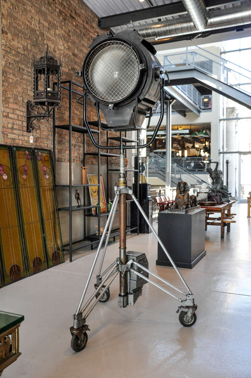 A second half of the 20th century American movie set spot light with adjustable legs on wheels. Not electrified for use in home, but can easily be retrofitted.